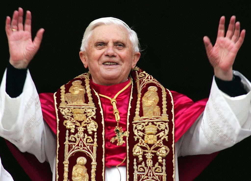 Newly elected Pope Joseph Ratzinger of Germany waves to the crowd from the central balcony of St. Peters Basilica, at the Vatican, Tuesday, April 19, 2005. (AP Photo/ Andrew Medichini)