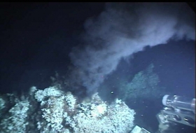 A hydrothermal vent releasing large amounts of iron forming iron clouds.