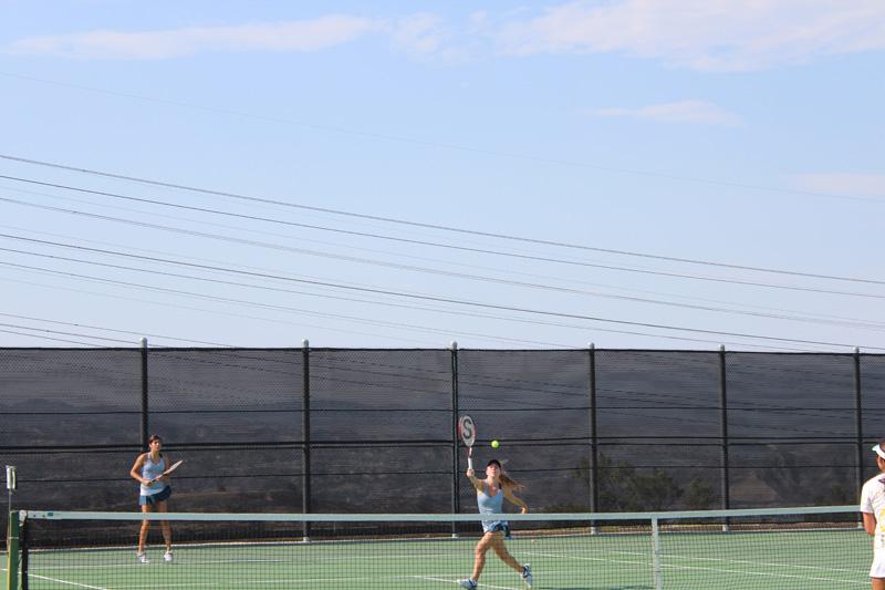 Sydney Schwartz hits a volley to her opponents.