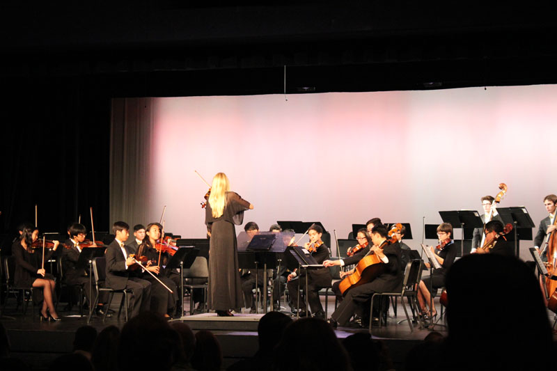 Concert-master Laura Tandy directs the Chamber Orchestra through tuning.