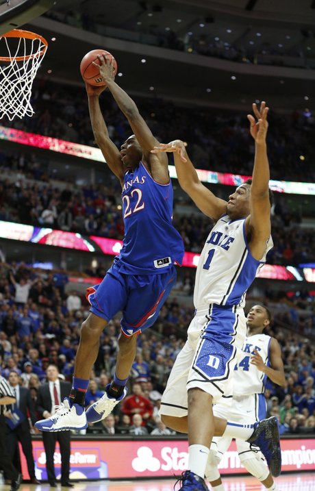Kansas forward Andrew Wiggins (22) flies in for a dunk to seal the game past Duke forward Jabari Parker (1) in the ESPN Champions Classic.
