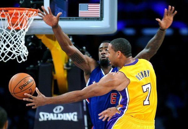 Lakers forward Xavier Henry (7) makes a play on Deandre Jordan (6) in a statement win over the Clippers.