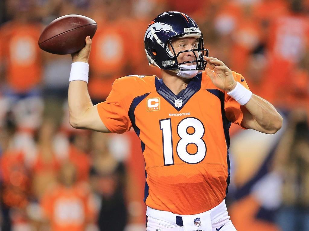 Peyton Manning attempts to throw a pass against the opposing defense.