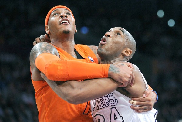 Carmelo Anthony and Kobe Bryant hug it out while battling for a rebound.  Is this a sign for future teammate embraces?