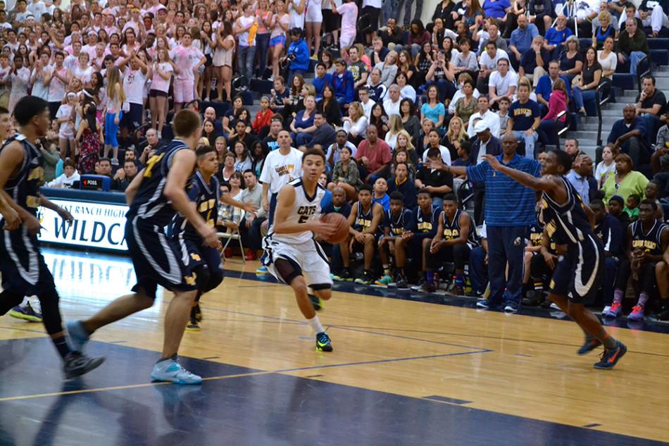 Junior guard Anthony Austin looks to drive the ball on a Rams defender.