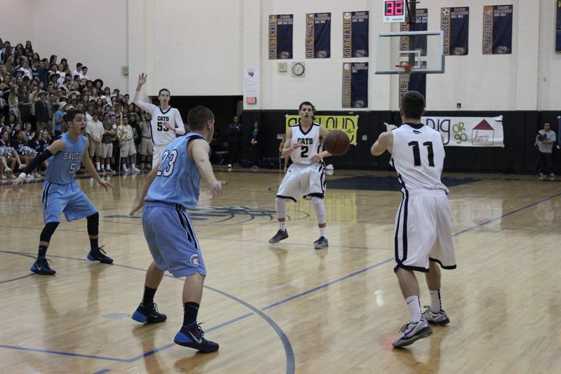 Senior Alec Weichel dishes the ball to sophomore Noah Peterson.