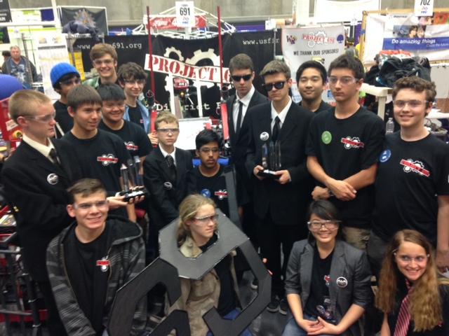 Project 691 members proudly show their trophy and accomplishments at the FIRST Central Valley Regional Competition. 
