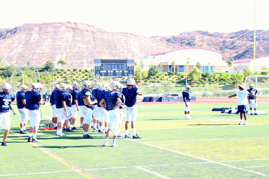 Coach Bridges gathers team together for a quick talk before practice.