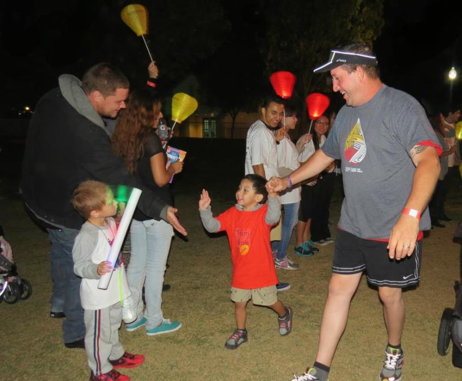 Santa Clarita Light the Night walkers receive high-fives from finishing the 1.5 mile walk.