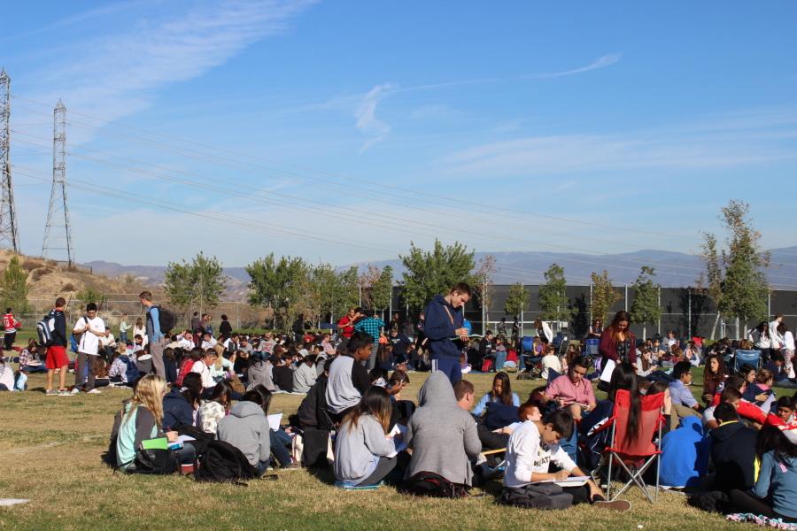 Students wait on the field during the earthquake drill.