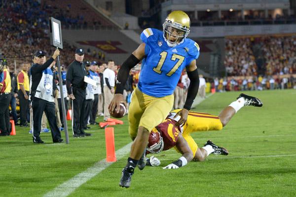 Quarterback Brett Hundley marches in for a touchdown to put the Bruins up by 24, but is not yet sure if he will recommit for his junior season.
