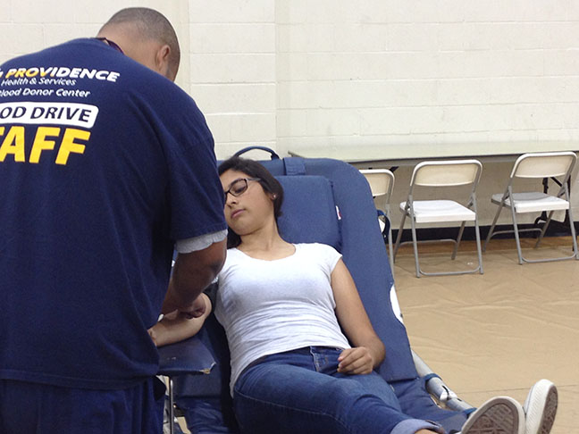 Junior Cristina Sanchez finishes donating her blood. 