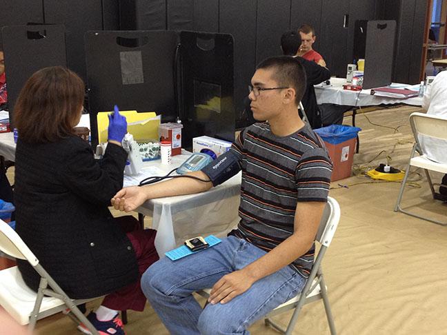 Junior Elias Combs has his blood pressure taken before donating his blood. 