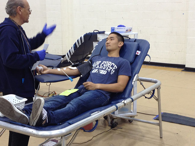 A nurse talks to senior Richard Kim as his blood is drawn out. 