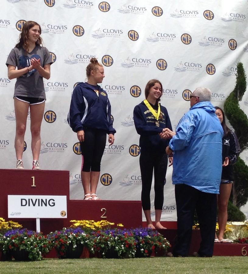 Carly Souza happily accepts her award after a fourth place finish at the state competition.