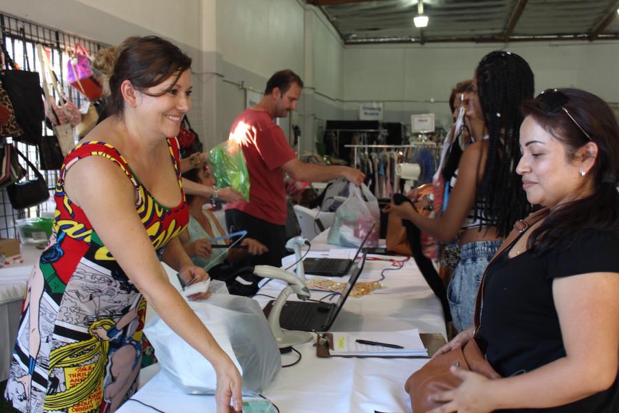 Owner of Dress On a Dime, Janell Costello, with a customer.