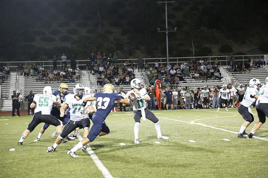 West Ranch's Mark McClafferty tries to sack the Thousand Oaks quarterback.