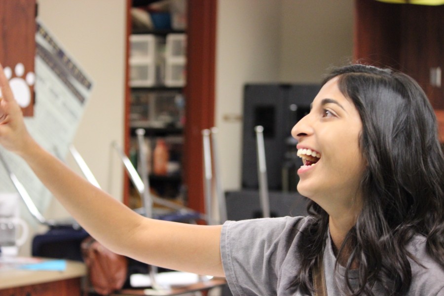 Although ASB events take a lot of hard work, rally preparation can be plenty of fun. Senior member Kelsey Fernando shows this as she smiles brightly while talking to fellow members.
