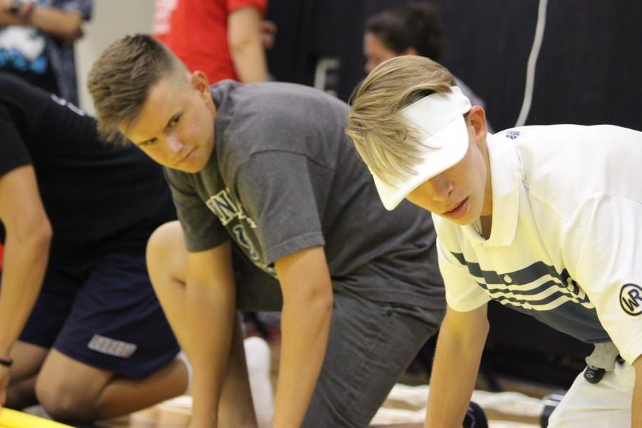 Seniors Jake Hettinger and Austin Stadt, veterans after four years of ASB work, roll out a poster together. “It’s a lot of work, but I think I’ll miss it when I’m gone.
