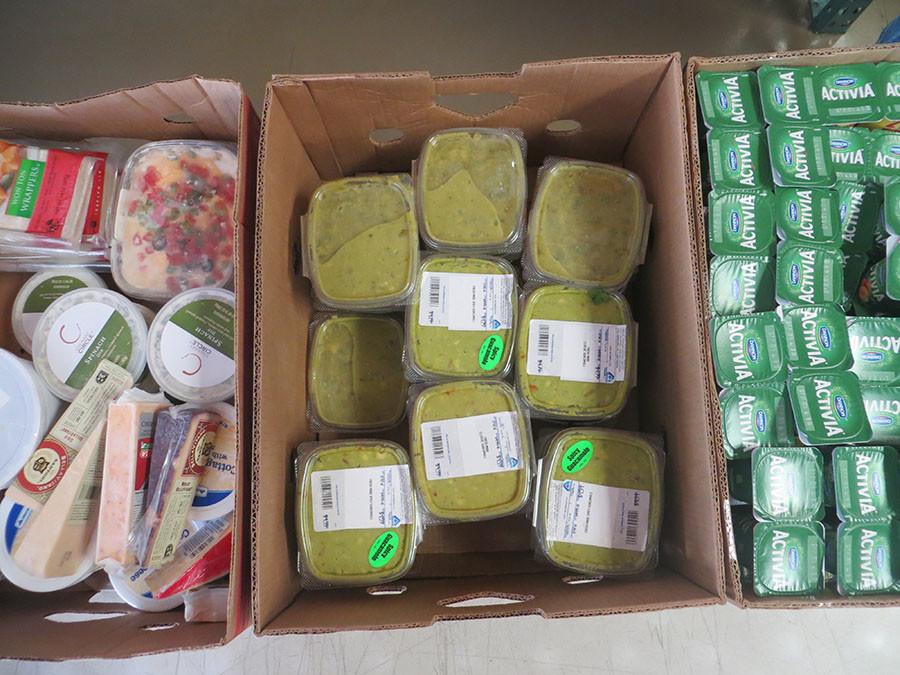 Volunteers store food in boxes.