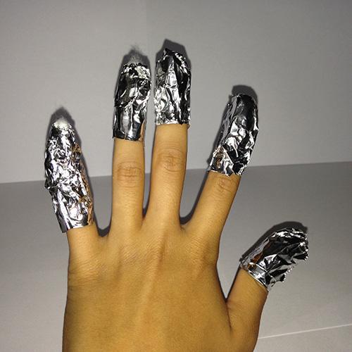 Wrap the foil over your finger and cotton ball.