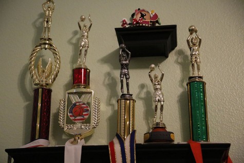 One shelf of trophies in Annie’s room displays her early passion and talent in her sport. 