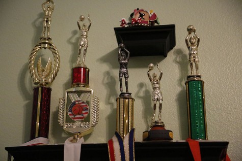 One shelf of trophies in Annie’s room displays her early passion and talent in her sport.