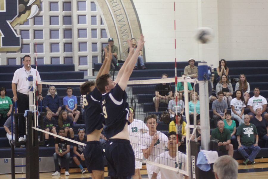 Middle Nicholas Christy and setter Ethan Marshall defending against South Torrences outside hitter