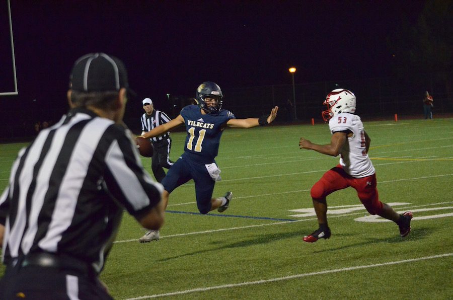 QB Wyatt Eget fights off a tackle with a stiff arm