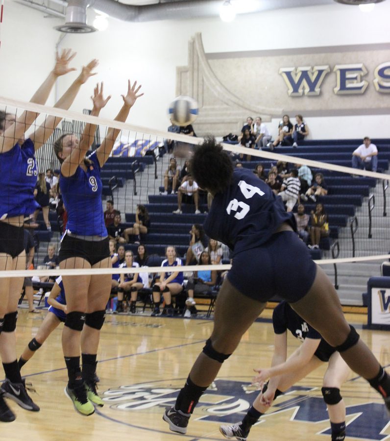 Lauren Smith spikes the ball into the deep corner past the block.