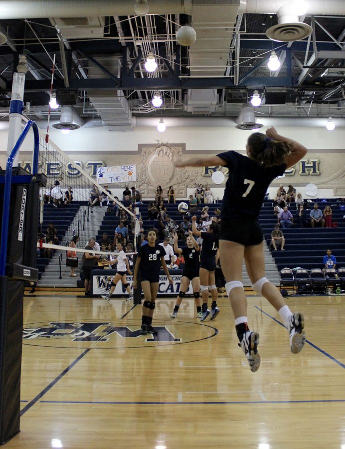 Allison Jacobs jumps to hit in pregame warm up.