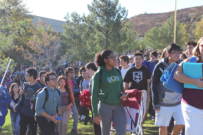Students following their teachers to their pre-assigned evacuation spot.