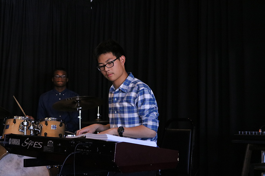 Luke Kim, senior, plays the piano during a jazz rendition of Carol of the Bells 