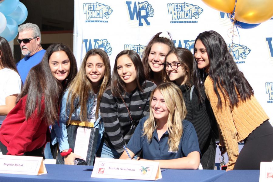 Sophie Bobal sits with he teammates and friends after signing her letter of intent. 