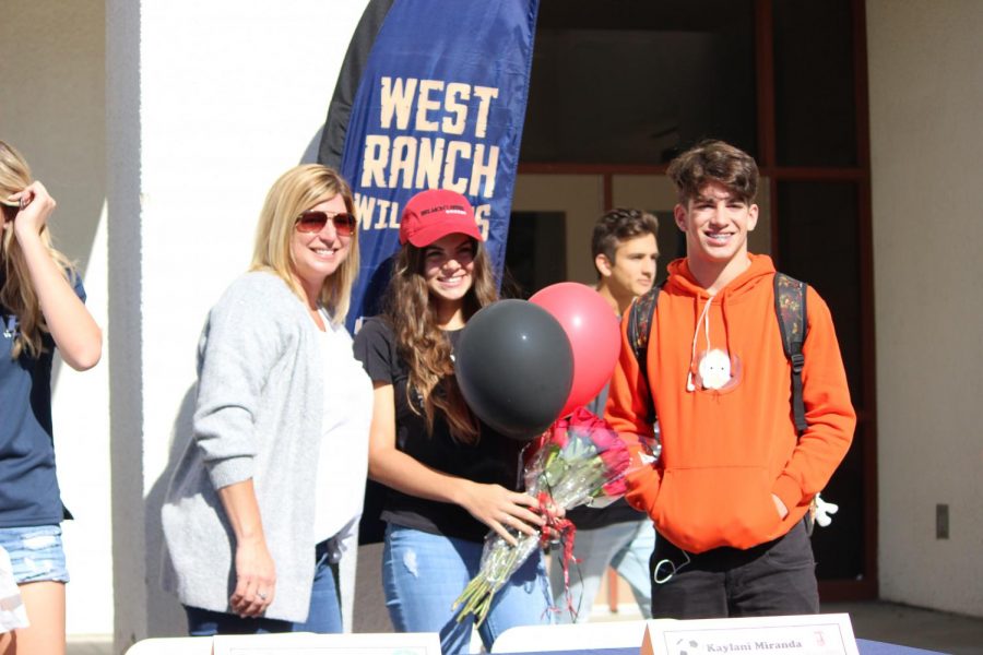 Kaylani Miranda stands with her family after signing her letter of intent. 