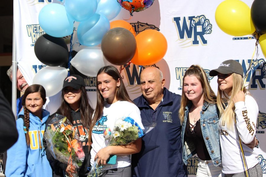 Gianna Lombardi stands with friends, family, and coaches after signing her letter of intent. 