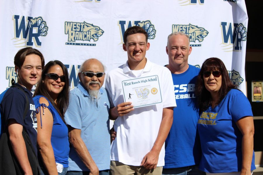 JD Callahan stands with friends, family, and coaches after signing his letter on intent. 