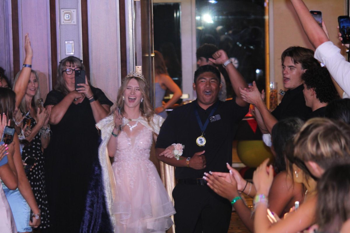 Homecoming Queen Victoria Hamilton being cheered on as she walks down. All photos by Nathan Lee and Erin Jung.